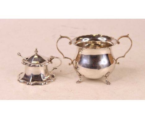 A George V silver sugar basin, having a shaped rim with twin scrolling handles, raised on shell feet, maker Francis Stebbins,