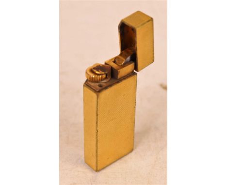 A Cartier textured gold plated cased pocket cigarette lighter, numbered 91688K