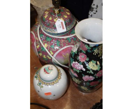 A famille noir vase, of baluster form, enamel decorated with pink and yellow flowers, h.32cm; together with a Chinese ginger 