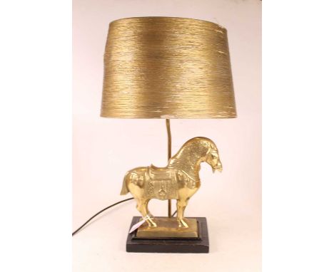 A modern table lamp, surmounted by a brass Trojan type horse, on an ebonised plinth, with shade, h.49cm 