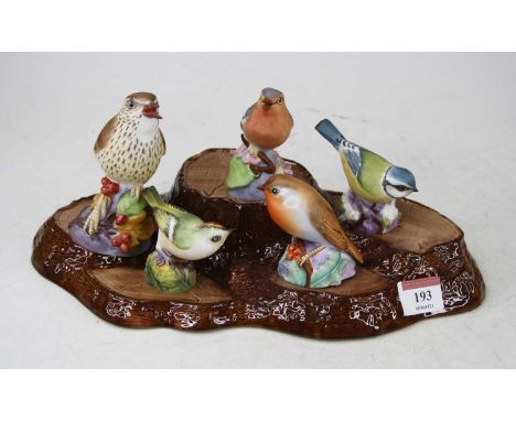 A collection of five Royal Worcester bird figures, including thrush 3234, robin 3197, bluetit 3199, goldcrest 3338, and chaff