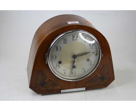 A 1930s walnut cased mantel clock, having a silvered dial with Arabic numerals, chiming movement, w.27cm