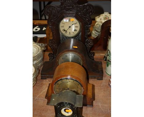 A late 19th century American carved walnut gingerbread type clock, having circular dial with eight day movement by the Ansoni