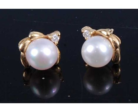 A pair of 18ct gold, cultured pearl and diamond point set ear studs (lacking backs), 2.6g, pearl dia.6.5mm