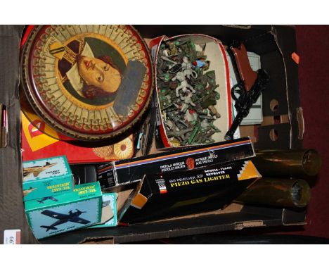 A box containing a collection of miscellaneous item to include brass shell cases, plastic army soldiers and a replica Luger p