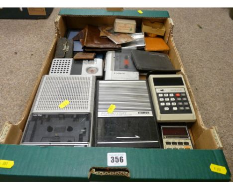 A selection of vintage cassette recorders, electronic calculators, leather wallets etc