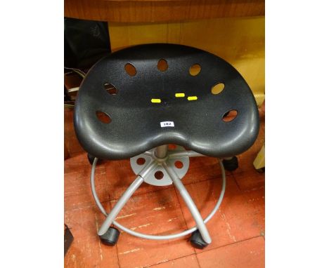 A low level wheeled stool with tractor-type seat