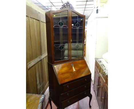 A vintage walnut full front bureau bookcase with leaded glass top doors