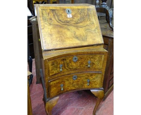 A vintage fall front walnut ladies bureau with concave lower drawers