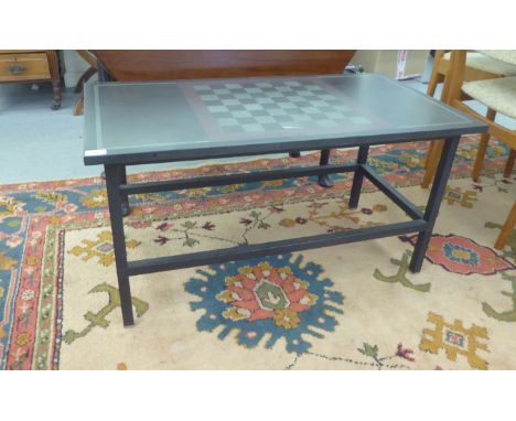 A modern two tone black/grey slate coffee table, the top with chessboard pattern, raised on square legs&nbsp; 19"h&nbsp; 37"w