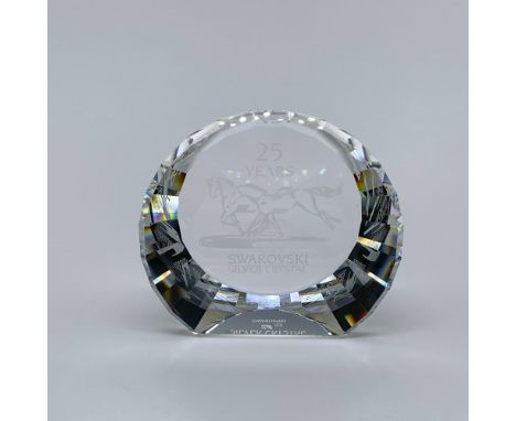 A clear crystal desk decor depicting wild horses in the center. An elegant piece that celebrates Swarovski Silver Crystal 25 