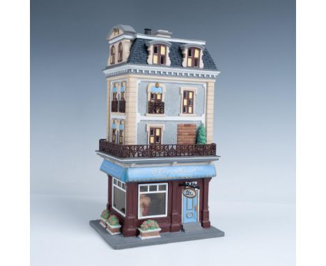 Quaint hand-painted ceramic building depicting a four story building with French restaurant on the main floor. A happy couple