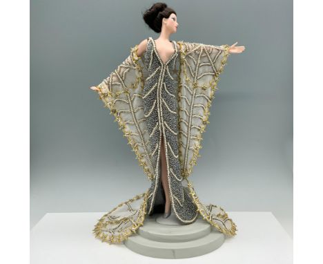 Limited edition figure of a beautiful blue eyed woman modeling a beaded gown and robe. This item has a base included 7"L x 5.