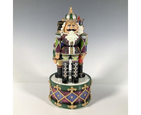 Charming resin music box featuring three vibrant nutcracker figures standing at attention atop a drum-shaped base. Song: The 