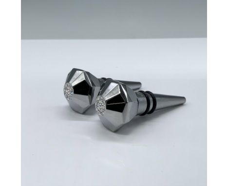 Stunning pair of stainless steel chrome stoppers featuring a luxurious, faceted metal design. Each is topped with elegant cir