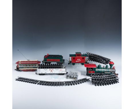 This grouping includes 5 cars, one in its box, 7 straight pieces of track, 11 curved pieces of track, a bag of decorative tre