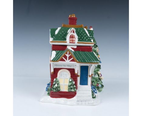 An adorable hand-painted figural cookie jar featuring a festive train station with a beautifully decorated Christmas tree out