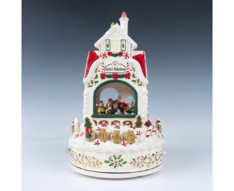 This whimsical hand-painted ceramic centerpiece features Santa and elves merrily whirling around the bakeshop with treats in 