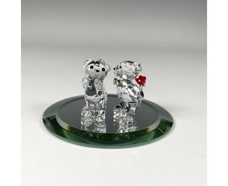 Charming figure capturing an adorable moment of a bear hiding a red rose, trying to kiss its smiling bear adorned with a ribb