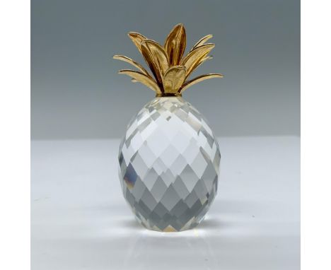 This crystal pineapple features smooth gold leaves with a fully faceted clear body. Swarovski SC logo mark. This item has its