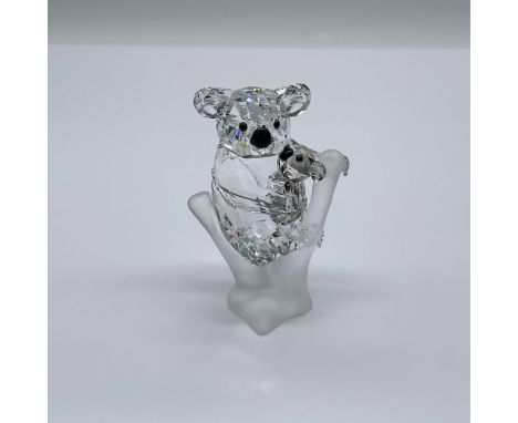 Part of the Rare Encounters collection. A mother koala in clear faceted crystal cradling her little cub in Golden Teak crysta