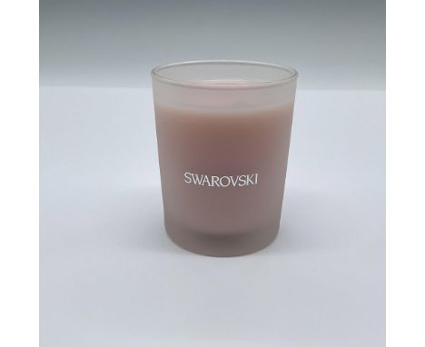 A pleasant scented pink candle in a frosted glass container. Swarovski marked in silvery text on the side. This item has its 