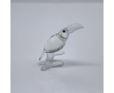 From the collection, Up In The Tree. A clear crystal bird with a frosted beak, resting on a frosted branch base. Swarovski sw