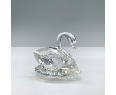 This swan paddles gracefully on a lake. In faceted clear crystal with an unfaceted neck and head. This item has its original 