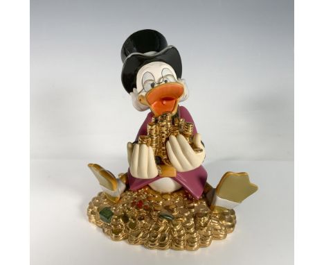 This matte finish figurine of Scrooge McDuck is sitting on and holding shiny gold coins. Scrooge is one of four pieces releas