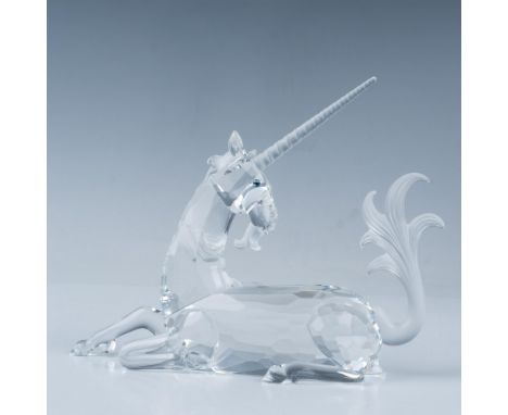 Faceted clear body, frosted mane, tail, and horn, elegantly posed lying down. 1996 Swarovski SCS member. This item has its or