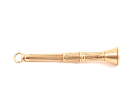 A 9 carat yellow gold cigar piercer, engine turned design, hallmarked Birmingham 1952, gross weight approximately 7.4gms.