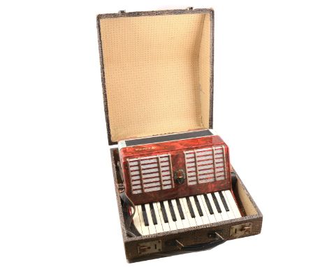 A Galotta piano accordion, red marbled body, 25 piano keys, in hard fitted case.
