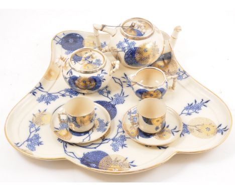 A Doulton Burslem Aesthetic style breakfast set, Japanese inspired design with blue and gilt printed roundels amongst floweri