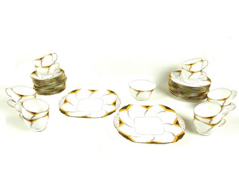 An Art Deco Fenton china tea service, twelve place settings, pattern number 6665, decorated in brown and gold against a white