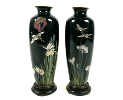 A pair of Japanese cloisonnŽ enamelled vases, early to mid 20th century, on midnight blue grounds, individually decorated wit