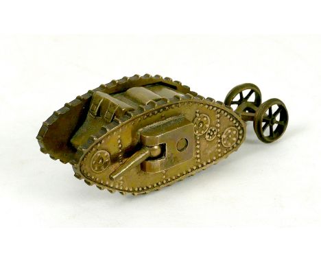 A WWI trench art brass Mk 1 tank, with two side guns, and rear steering wheels, 13 by 4.8 by 4.2cm high.