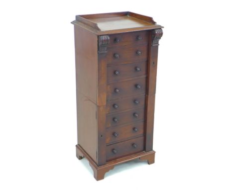 A small 19th century mahogany Wellington chest of drawers, in two sections, with three quarter upstand to the upper surface, 