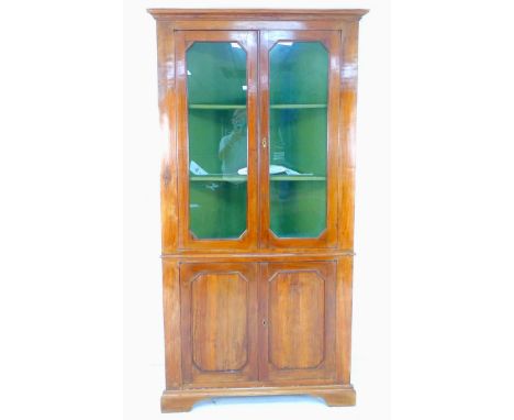 An Italian 19th century corner cabinet, cornice over twin glazed doors enclosing two fixed shelves, painted green internally,