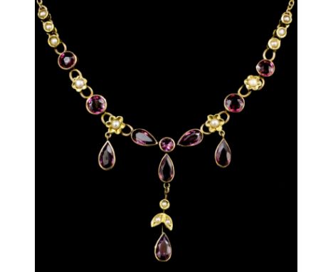 A late Victorian gold coloured metal mounted amethyst and seed pearl set necklace, the face set with six tear drop cut amethy