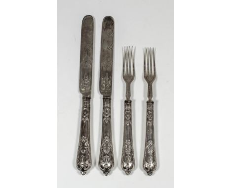 A set of six Victorian silver fruit knives and forks, the handles embossed with strapwork ornament, the blades similarly engr