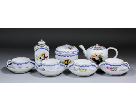 A Meissen porcelain part tea service enamelled in colours with sprays of flowers, fruit and vegetables within blue and gilt r
