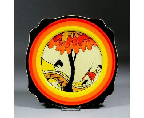 A Clarice Cliff pottery Fantasque/Bizarre design plate of shaped outline, painted with "House and Bridge" design, 9.75ins dia