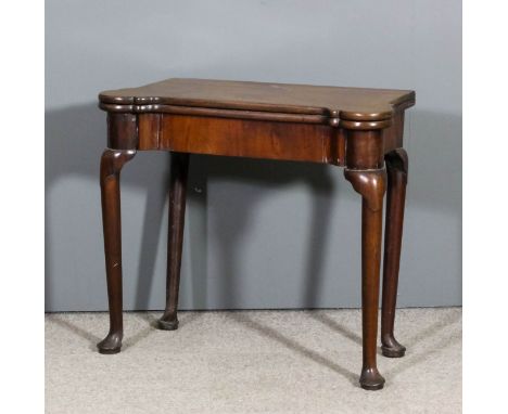 A George II 'Cuban' mahogany rectangular card table with bold rounded front corners, the baize lined folding top with circula