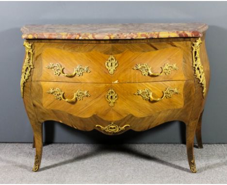 A French kingwood and gilt metal mounted bombe shaped commode of Louis XV design and of serpentine outline, the pink flecked 