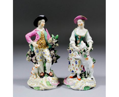 A pair of 18th Century Derby porcelain figures of a male figure and his companion, he with a dog and she with a sheep, each 7