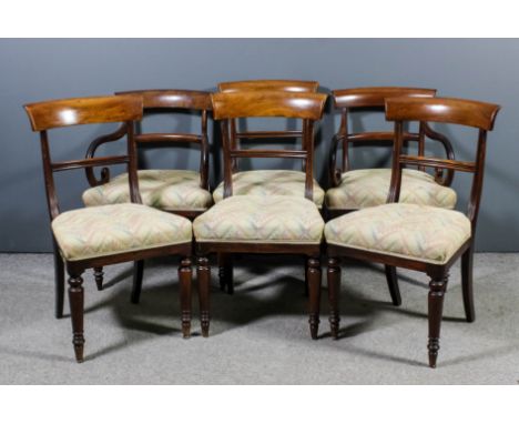 Four George IV mahogany dining chairs with plain curved crest rails, the seats upholstered in pink and cream tapestry, on tur