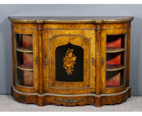 A Victorian figured walnut and gilt metal mounted credenza of serpentine outline, the whole crossbanded, fitted one shelf enc