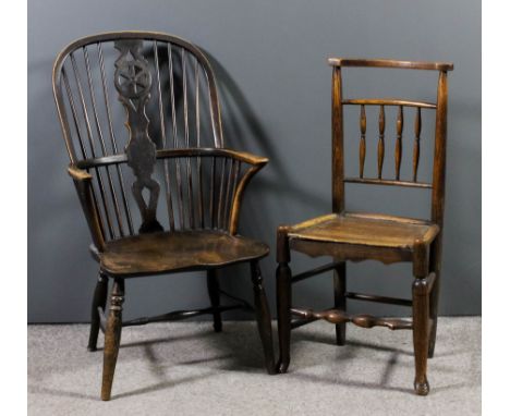 A 19th Century ash and elm seated wheel and stick back Windsor armchair with two tier back, on turned supports and H-pattern 