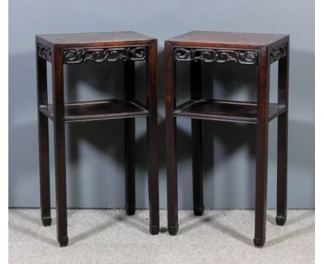 A pair of Chinese rosewood rectangular two tier occasional tables with flush panels to top, the aprons fretted and carved wit