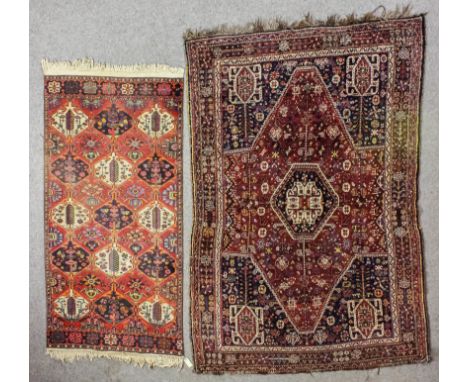 A North-West Persian rug woven in dark colours with a central pole medallion with hexagonal panel to centre and stylised flor